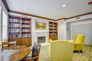 A room with a fireplace and a table and chairs
